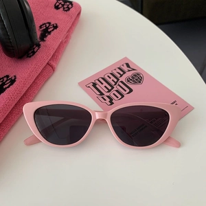 Stylish pink cat-eye sunglasses for women featuring dark lenses and retro fashion design