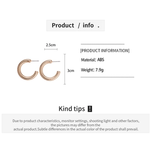 Detail shot of C-shaped rose gold geometric earrings with textured surface and size specs