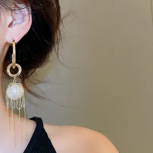 French style long gold pearl tassel earrings with fine chain dangles for a luxury look