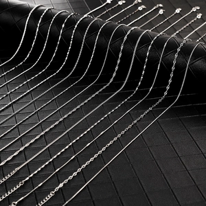 Selection of silver chain necklaces including snake, wave, and box links on leather