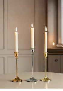 Detailed view of elegant gold, silver, and champagne metal taper candle holders