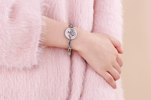 Silver tree of life charm bracelet with sparkling crystals on a woman's wrist