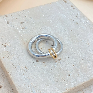 Minimalist stainless steel double band ring with gold connectors on stone base