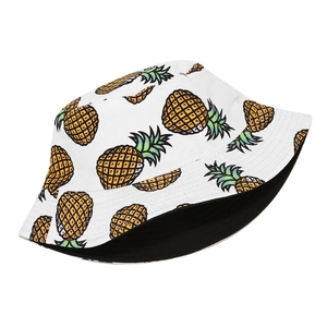 Reversible cotton bucket hat with yellow pineapple print and black inner sun protection