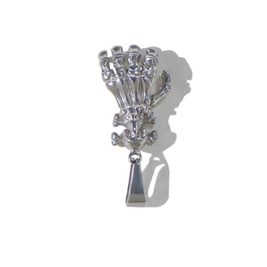 Macro detail of silver stainless steel skeleton hand holding a skull pendant on white background