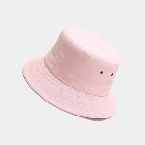 Detail view of pink bucket hat with circular S letter embroidery and metal eyelets