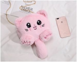Pink plush cat shoulder bag with gold metal chain next to an iPhone for size scale