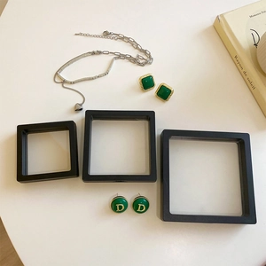 Macro view of black PE film jewelry boxes in various sizes showing anti-oxidation film detail