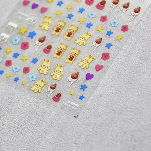Macro detail of 5D embossed nail stickers featuring cute cartoon bears and rabbits