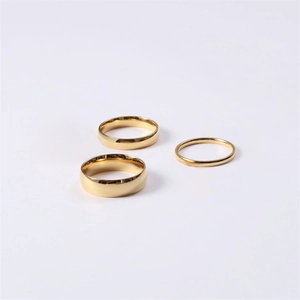 Polished gold stainless steel rings set in three widths on a clean white background