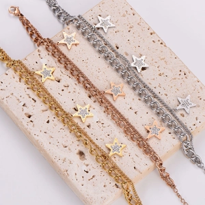 Detailed view of gold, rose gold and silver star bracelets on a stone display