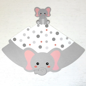 Flat lay detail of a DIY cartoon elephant party hat made from thick grey cardboard