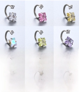 Macro shot of titanium steel horseshoe rings with colorful cubic zirconia in 6 vibrant colors