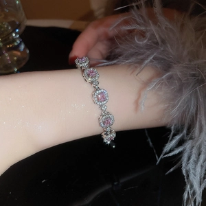 Detail of luxury geometric bracelet with pink sparkling square gemstones and silver settings