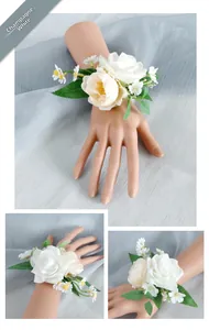 Detail of champagne white rose wrist corsage with silk petals and green leaves