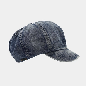 Detailed side view of stonewashed dark blue denim newsboy cap with vintage stitching