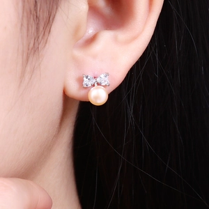 Elegant bow-knot heart-shaped earrings with pink freshwater pearls and crystals on ear