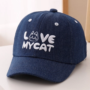 Detail of navy blue denim baseball cap featuring white LOVE MY CAT embroidery and cat motif