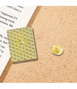 Detailed macro view of the gold plated butterfly clasp and honeycomb textured metal pin back