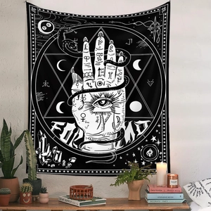 Detailed view of bohemian tapestry featuring mystical eye and serpent on a white wall
