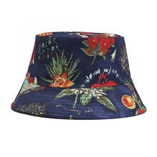 Detailed view of the dark blue tie-dye bucket hat featuring tropical floral patterns