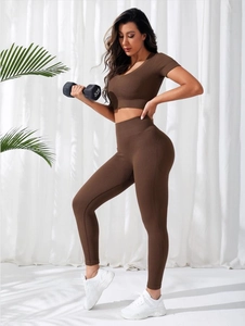 Detail of high-stretch ribbed seamless yoga set showing brown V-neck crop top and leggings