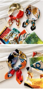 Close-up of silk square scarves with vintage floral and geometric patterns in rich colors