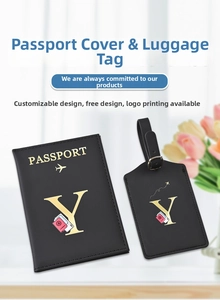 Close-up of black PU leather passport cover and luggage tag with gold foil lettering