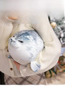 Soft seal plush toy held by a model in a cozy Christmas setting for relaxation