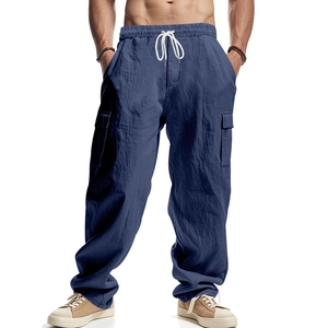 Detail of navy blue cargo pants with drawstring waist and spacious side utility pockets