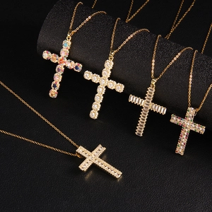 Gold plated cross necklace set with sparkling cubic zirconia on luxury jewelry display