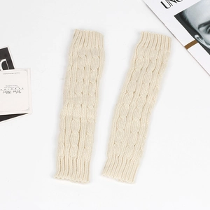 Close-up of cream cable knit texture on long fingerless gloves for winter warmth