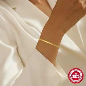 Elegant 925 sterling silver triple snake bone chain bracelet in gold finish on model wrist