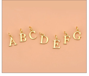 Close-up of golden letter pendants A to G for DIY 925 silver jewelry making