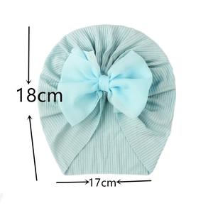 Detail of baby turban hat showing light blue ribbed knit fabric and tulle bow dimensions