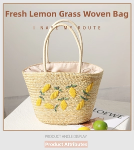 Close-up of a straw tote bag featuring detailed lemon embroidery and a drawstring closure