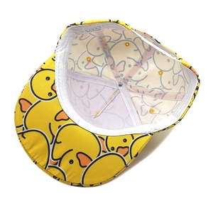 Detail view of polyester flat brim baseball cap with yellow cartoon duck pattern