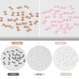 3D mini bow nail art charms in gold, pink and white colors for manicure decoration