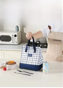 Macro detail of checkered lunch bag with reinforced handle and thermal lock label