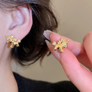 Detailed close-up of gold unicorn stud earrings with sparkling crystals for women