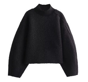 Detailed texture of black knit fabric on a mock neck pullover sweatshirt for women