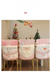 Detail of pink Christmas chair covers with 3D Santa, reindeer, and snowman plush designs
