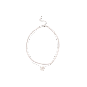 Elegant multi-layer necklace with white pearls and a silver flower pendant on white back