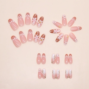 Detail of French almond press-on nails with ice floral and polka dot patterns