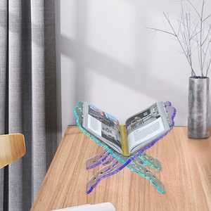 Iridescent acrylic X-frame book stand with colorful laser gradient on wooden desk