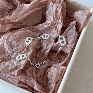 Close-up of S925 sterling silver pig nose link bracelet with adjustable chain on brown paper