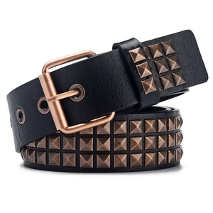 Close-up of punk style black leather belt featuring triple row of bronze pyramid studs