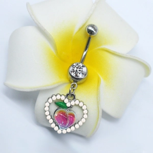 Detailed view of peach heart navel ring on frangipani flower with pearls and zircons