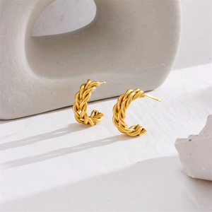 Elegant gold plated stainless steel twisted rope hoop earrings on white stone