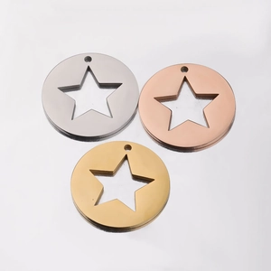 Three stainless steel round pendants with star cutouts in silver, rose gold, and gold